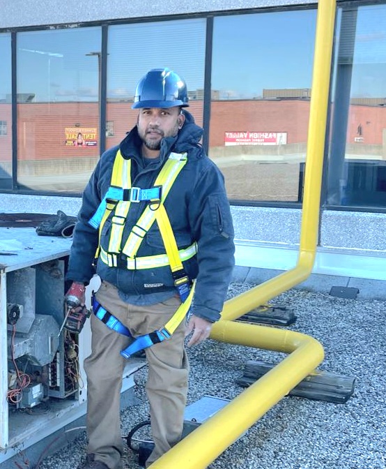 Lead HVAC technician installing equipment